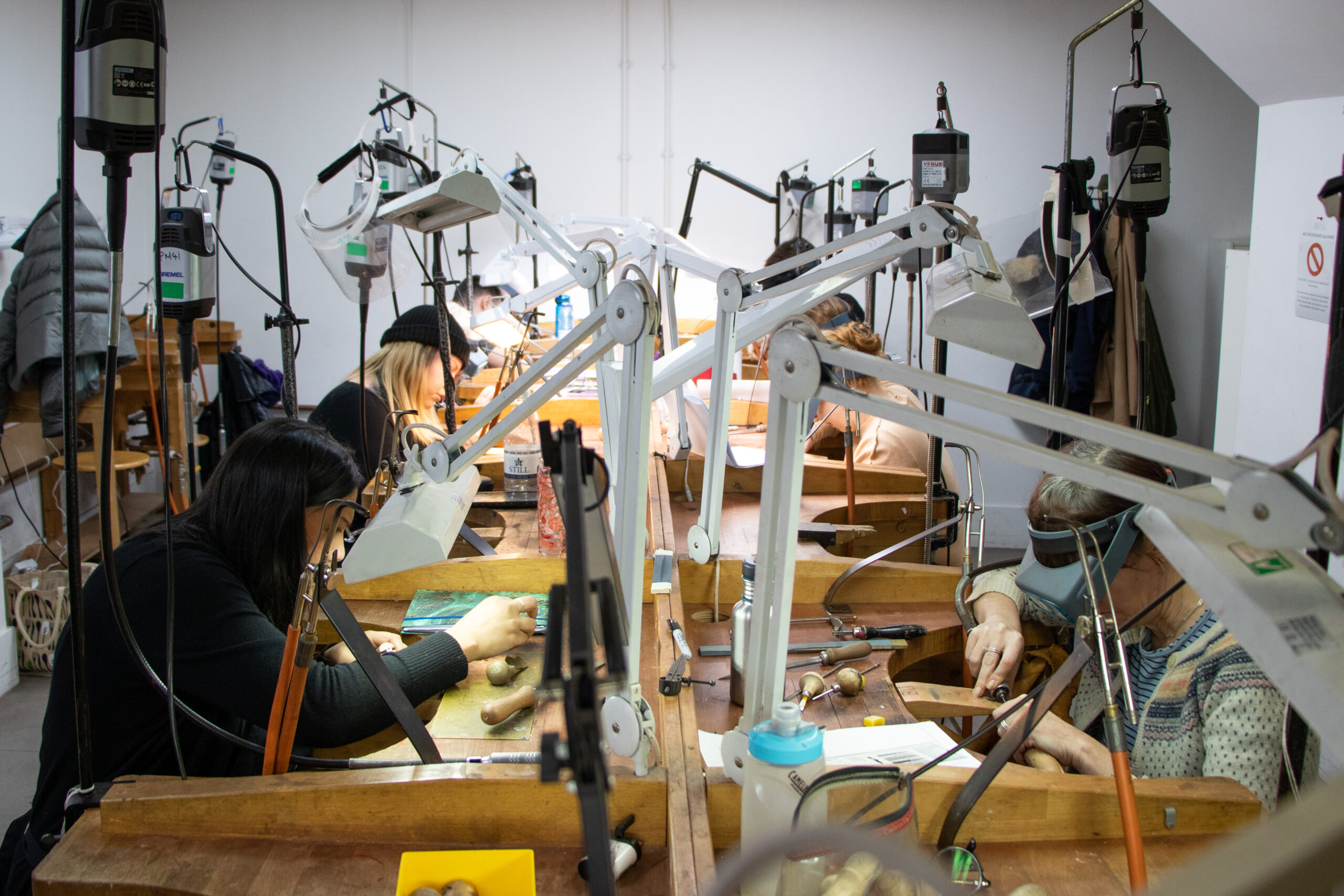 A Jewellery workshop with multiple students working.