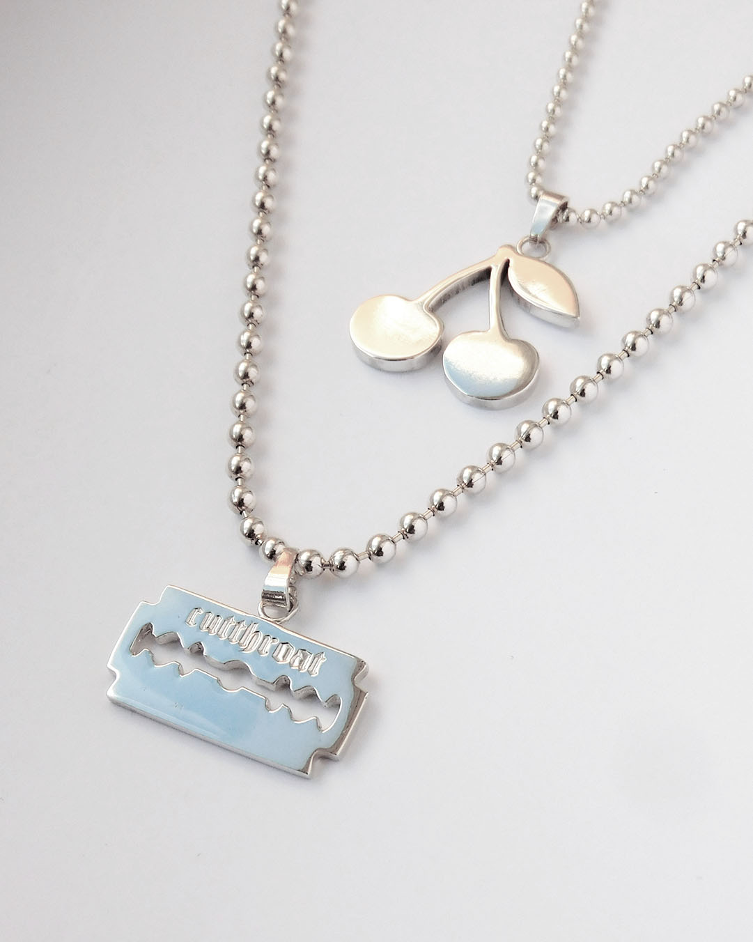 Image_Alumni work_Yvonne Oshodi of Silver in Chaos_silver cherry and razor blade necklaces_beaded link chain_2025-11-06